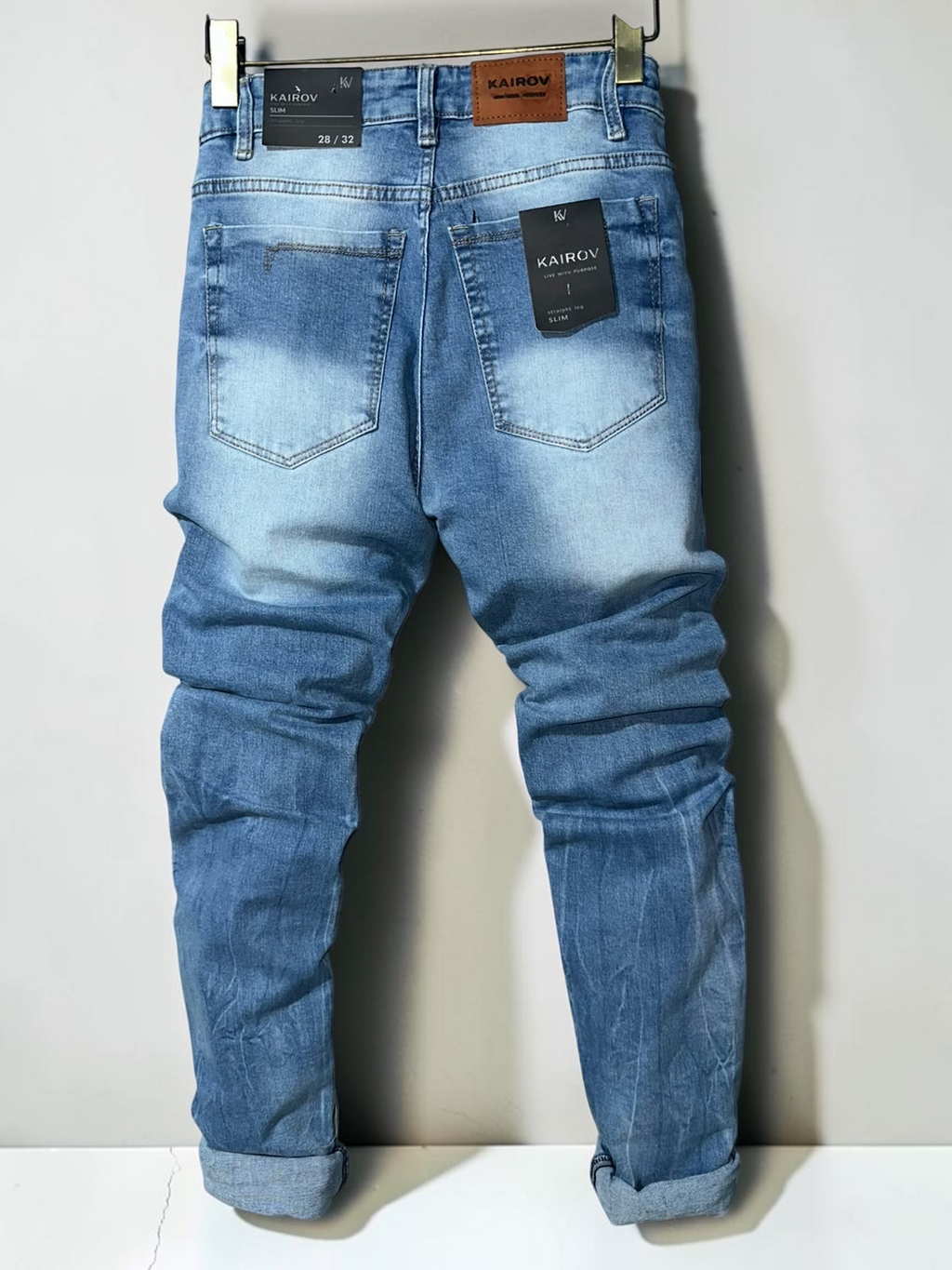 Pantalones de mezclilla Mi tienda KAIROV corte slim en azul claro con acabado deslavado y etiqueta de cuero trasera