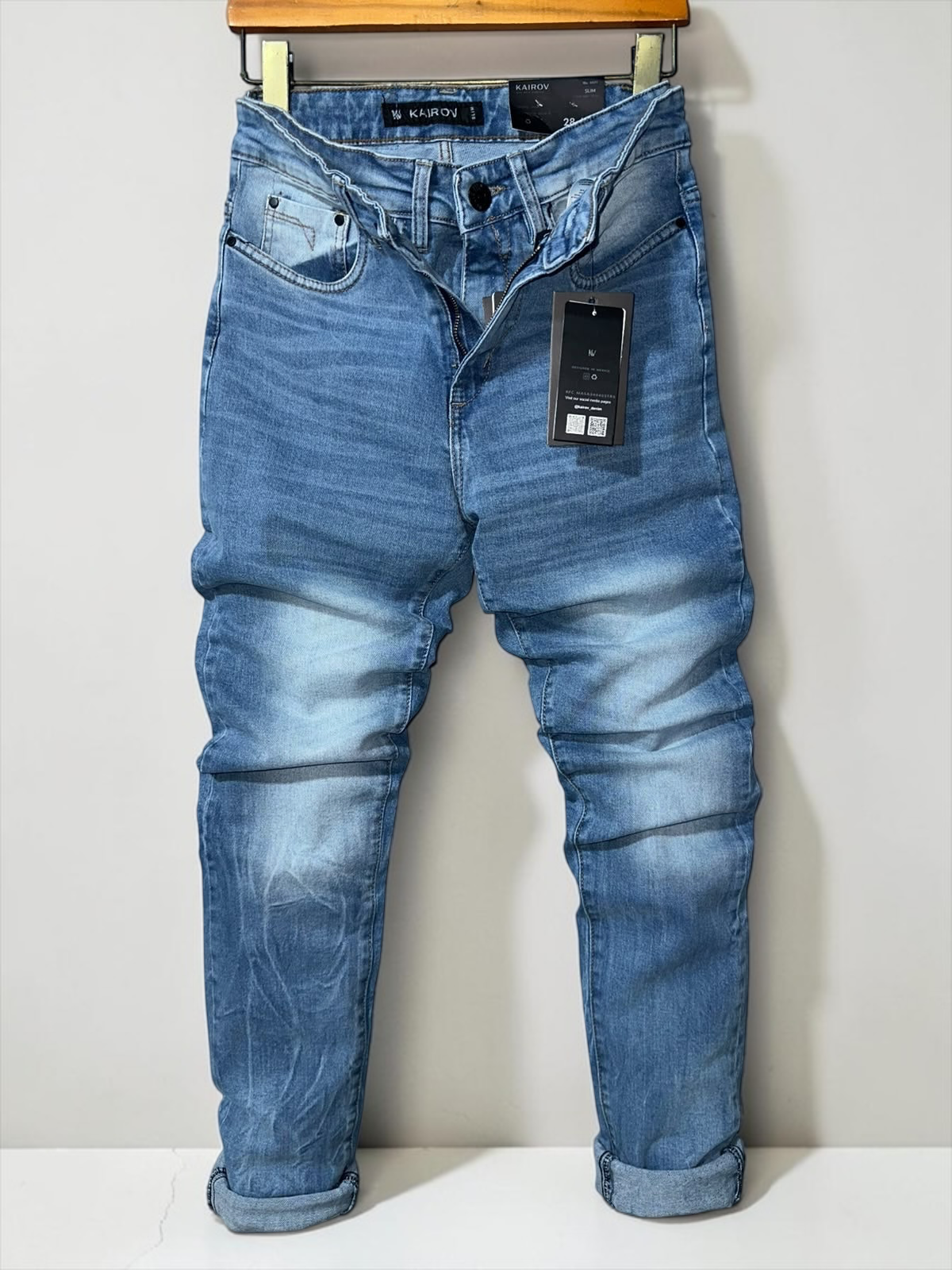 Jeans de mezclilla Mi tienda KAIROV en azul claro con corte slim, acabado deslavado y etiqueta de cuero en la cintura.